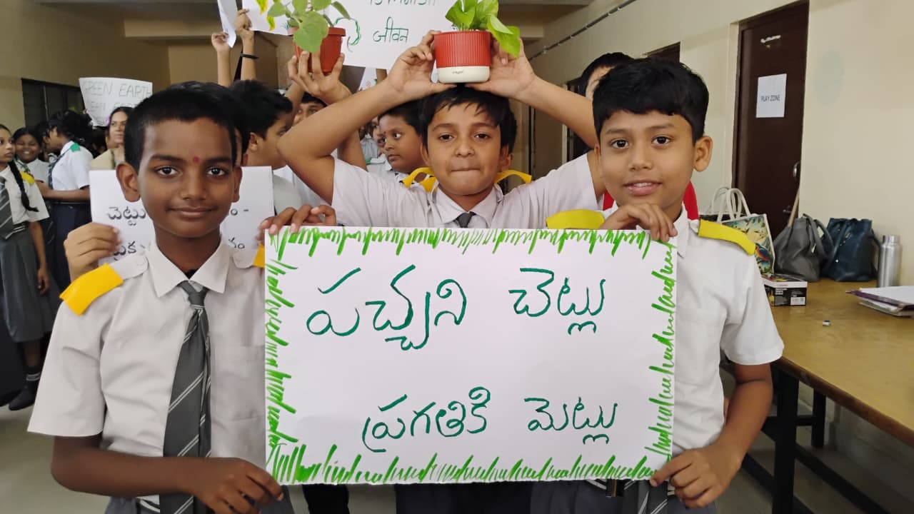 Students with saplings and Telugu green-earth placards