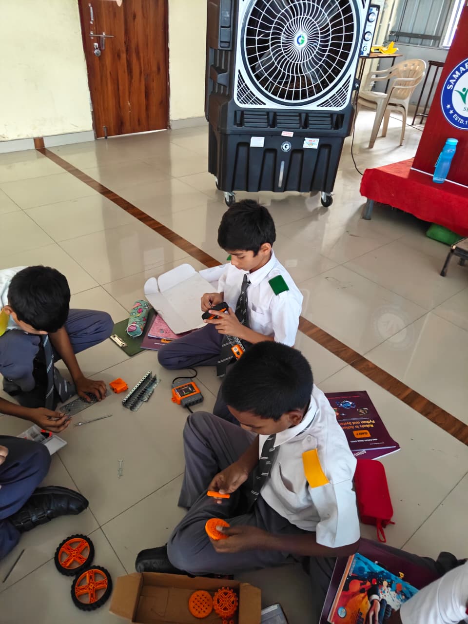 Students assembling robot components